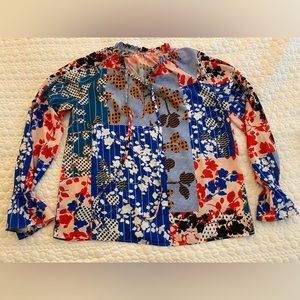 Multi print blouse. Tie neck. Elastic cuff sleeve.